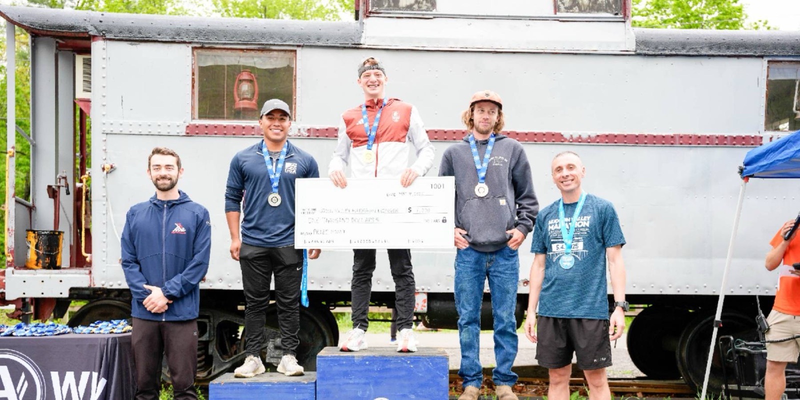 Hudson Valley Marathon overall winners on the podium with the prize money check